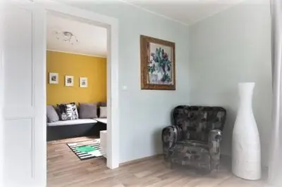 a living room with a chair and a couch at Dreamy Apartment in Prague