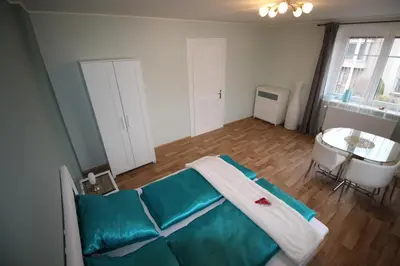 a room with a bed and a table in it at Dreamy Apartment in Prague