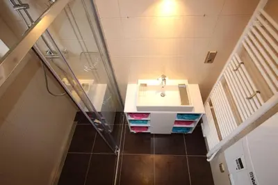 a bathroom with a sink and a glass shower at Dreamy Apartment in Prague