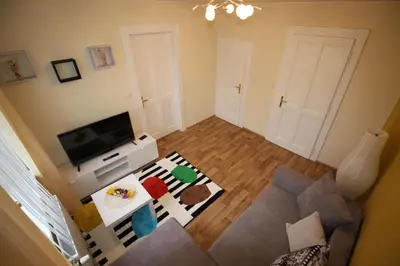a small living room with a tv and a couch at Dreamy Apartment in Prague