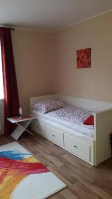 a bedroom with a white bed and a table at Dreamy Apartment in Prague