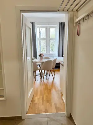 a dining room with a table and chairs and a window at Stylish 2BR with stunning view of National Muzeum in Prague