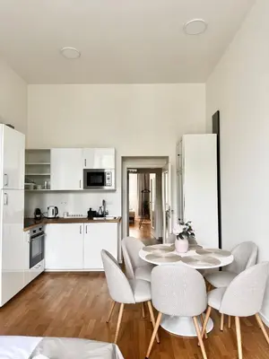 a kitchen and dining room with a table and chairs at Stylish 2BR with stunning view of National Muzeum in Prague
