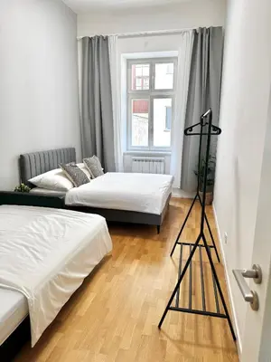 a room with two beds and a tripod in it at Stylish 2BR with stunning view of National Muzeum in Prague