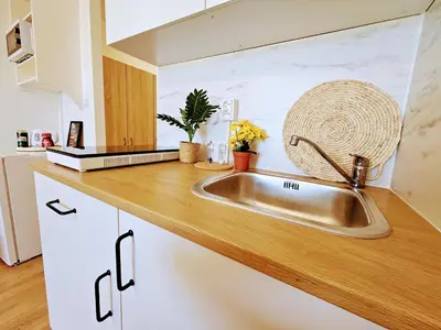 a kitchen counter with a sink in a kitchen at LIVE-INN PRAGUE 1 BDR CITY VIEW SUITE FOR 1-4 GUESTS, 20 Mins to center, Lift, Gym, Reception, Parking, Roof Terrace, Game & Party in Prague