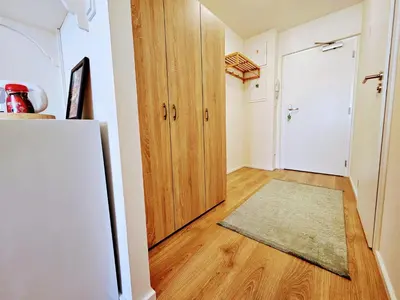 a kitchen with a refrigerator and a hallway with a door at LIVE-INN PRAGUE 1 BDR CITY VIEW SUITE FOR 1-4 GUESTS, 20 Mins to center, Lift, Gym, Reception, Parking, Roof Terrace, Game & Party in Prague