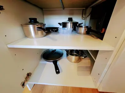a kitchen with two pots and pans on a shelf at LIVE-INN PRAGUE 1 BDR CITY VIEW SUITE FOR 1-4 GUESTS, 20 Mins to center, Lift, Gym, Reception, Parking, Roof Terrace, Game & Party in Prague