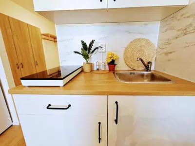 a kitchen counter with a sink and a laptop on it at LIVE-INN PRAGUE 1 BDR CITY VIEW SUITE FOR 1-4 GUESTS, 20 Mins to center, Lift, Gym, Reception, Parking, Roof Terrace, Game & Party in Prague