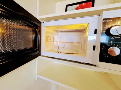 a microwave oven with its door open in a kitchen at LIVE-INN PRAGUE 1 BDR CITY VIEW SUITE FOR 1-4 GUESTS, 20 Mins to center, Lift, Gym, Reception, Parking, Roof Terrace, Game & Party in Prague