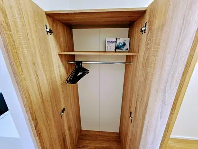 a room with a closet with wooden walls and a door at LIVE-INN PRAGUE 1 BDR CITY VIEW SUITE FOR 1-4 GUESTS, 20 Mins to center, Lift, Gym, Reception, Parking, Roof Terrace, Game & Party in Prague