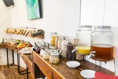a counter with many jars of food on it at Miss Sophie's New Town & Wellness in Prague