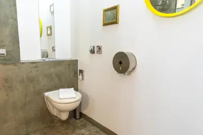 a bathroom with a toilet and a mirror on the wall at Miss Sophie's New Town & Wellness in Prague