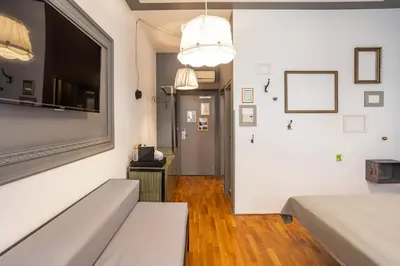 a living room with a couch and a television at Miss Sophie's New Town & Wellness in Prague