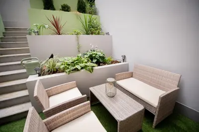 a patio with a table and chairs and plants at The Wenceslas Square Terrace in Prague