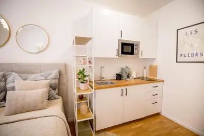 a small bedroom with a bed and a sink at The Wenceslas Square Terrace in Prague