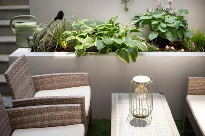 a patio with a table and chairs and plants at The Wenceslas Square Terrace in Prague
