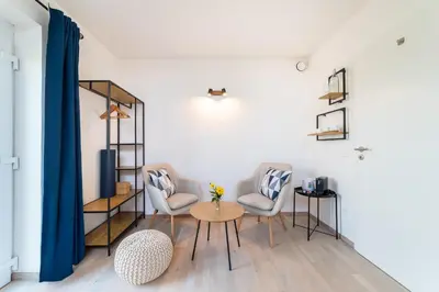 a living room with two chairs and a table at TinyGreens B & B in Poděbrady