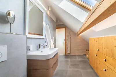 a bathroom with a white sink and a skylight at TinyGreens B & B in Poděbrady