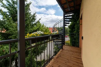 a balcony with a view of a garden at TinyGreens B & B in Poděbrady