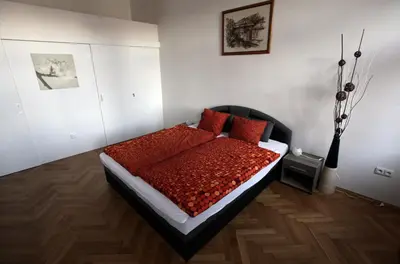 a bedroom with a bed with red pillows on it at Carpe Diem Prague in Prague