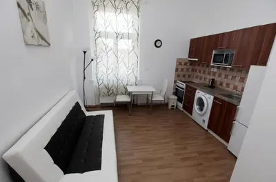 a kitchen with a washer and dryer in a room at Carpe Diem Prague in Prague