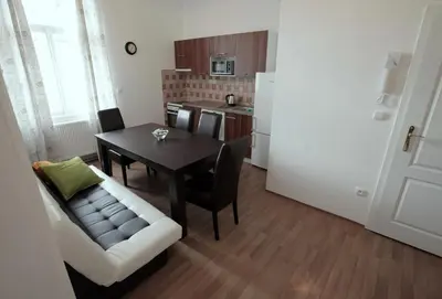 a kitchen and dining room with a table and a couch at Carpe Diem Prague in Prague