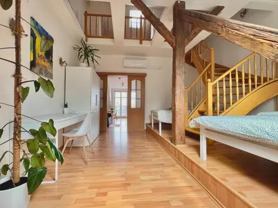 a home with a staircase and a living room at Rooftop Prague view apartment in Prague