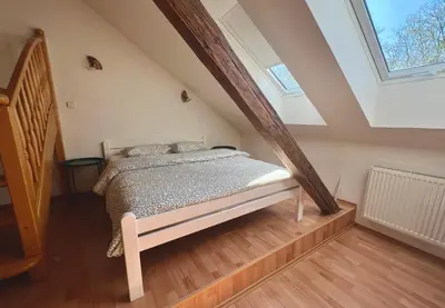 a bedroom with a bed in a attic at Rooftop Prague view apartment in Prague