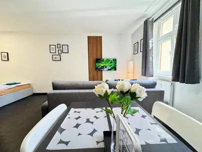 a living room with a table and a couch at A comfy apartment in Smíchov - Anděl in Prague