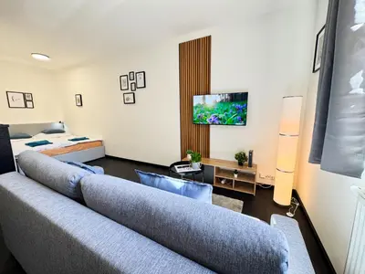 a living room with two couches and a tv at A comfy apartment in Smíchov - Anděl in Prague
