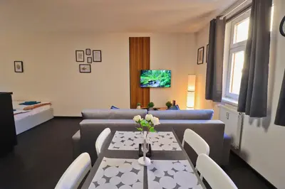 a living room with a couch and a table at A comfy apartment in Smíchov - Anděl in Prague