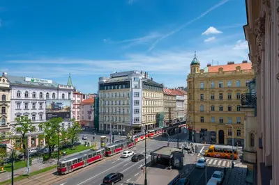 a city with buses and cars on a street at PavlaCzech Art Apartment in Prague