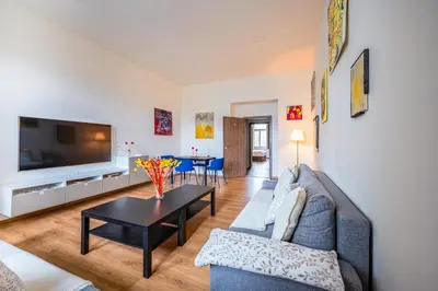 a living room with a couch and a table at PavlaCzech Art Apartment in Prague
