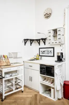 a kitchen with white cabinets and a counter top at Royal Charlie Suite in Prague