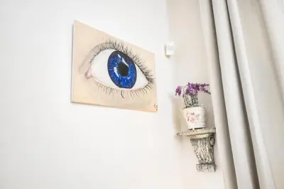 a picture of a blue eye hanging on a door at Royal Charlie Suite in Prague