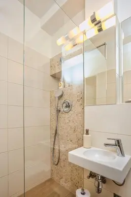 a bathroom with a shower and a sink at Royal Charlie Suite in Prague