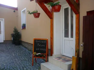 a chalkboard sign on the side of a building at Apartment Patera in Unhošť