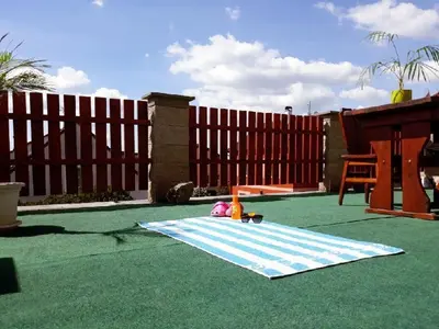 a toy doll sitting on a blanket in a backyard at Apartment Patera in Unhošť