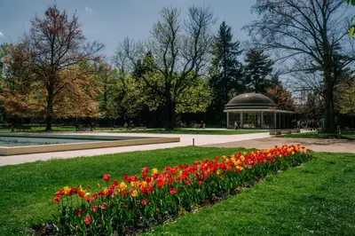 a park with red and orange flowers and a gazebo at Apartmán Slunce in Poděbrady