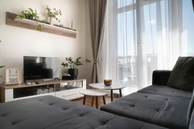 a living room with a couch and a tv at Apartmán Slunce in Poděbrady