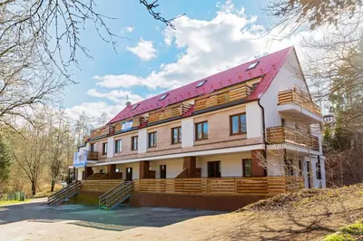 a building with a red roof on top of it at Útulný apartmán na Slapech in Čím
