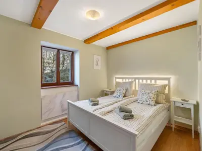 a bedroom with a large white bed with a window at Holiday Home Svatá by Interhome in Svatá
