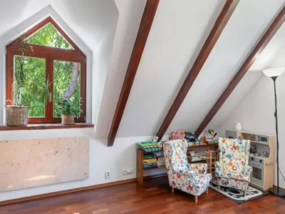 a attic room with a window and a desk and chairs at Holiday Home Svatá by Interhome in Svatá