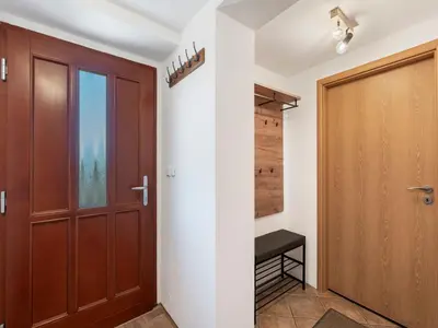 a hallway with a wooden door and a bench at Holiday Home Svatá by Interhome in Svatá