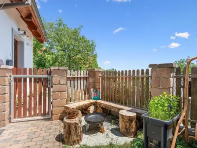 a backyard with a wooden fence and a fire pit at Holiday Home Svatá by Interhome in Svatá