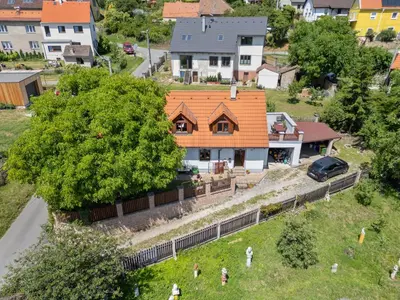 a house with an orange roof in a residential neighborhood at Holiday Home Svatá by Interhome in Svatá