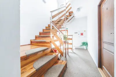 a staircase in a home with benches and wooden floors at Hotel Bohemia in Stará Boleslav