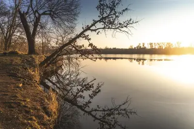 a view of a lake at sunset at Hotel Bohemia in Stará Boleslav