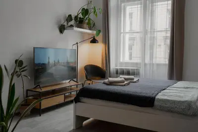 a bedroom with a bed and a flat screen tv at Cozy warm studio in Prague city center in Prague