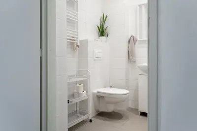 a white bathroom with a toilet and a sink at Cozy warm studio in Prague city center in Prague